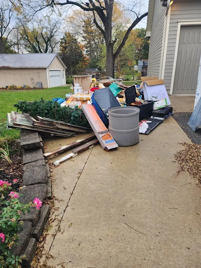 Dumpster being loaded with debris for Estate Cleanout Dumpster Rental in Nassau Village-Ratliff